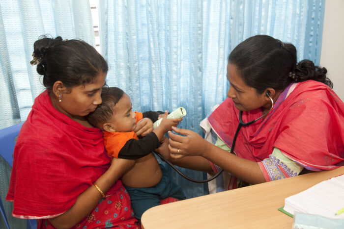 A medical professional listened to a child's heartbeat with a stethoscope